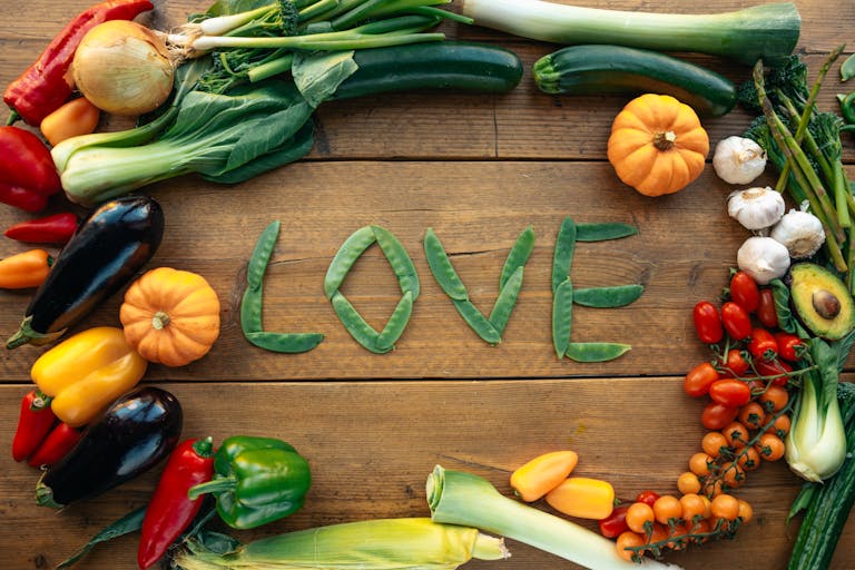 A vibrant display of assorted vegetables forming the word love, symbolizing healthy eating.
