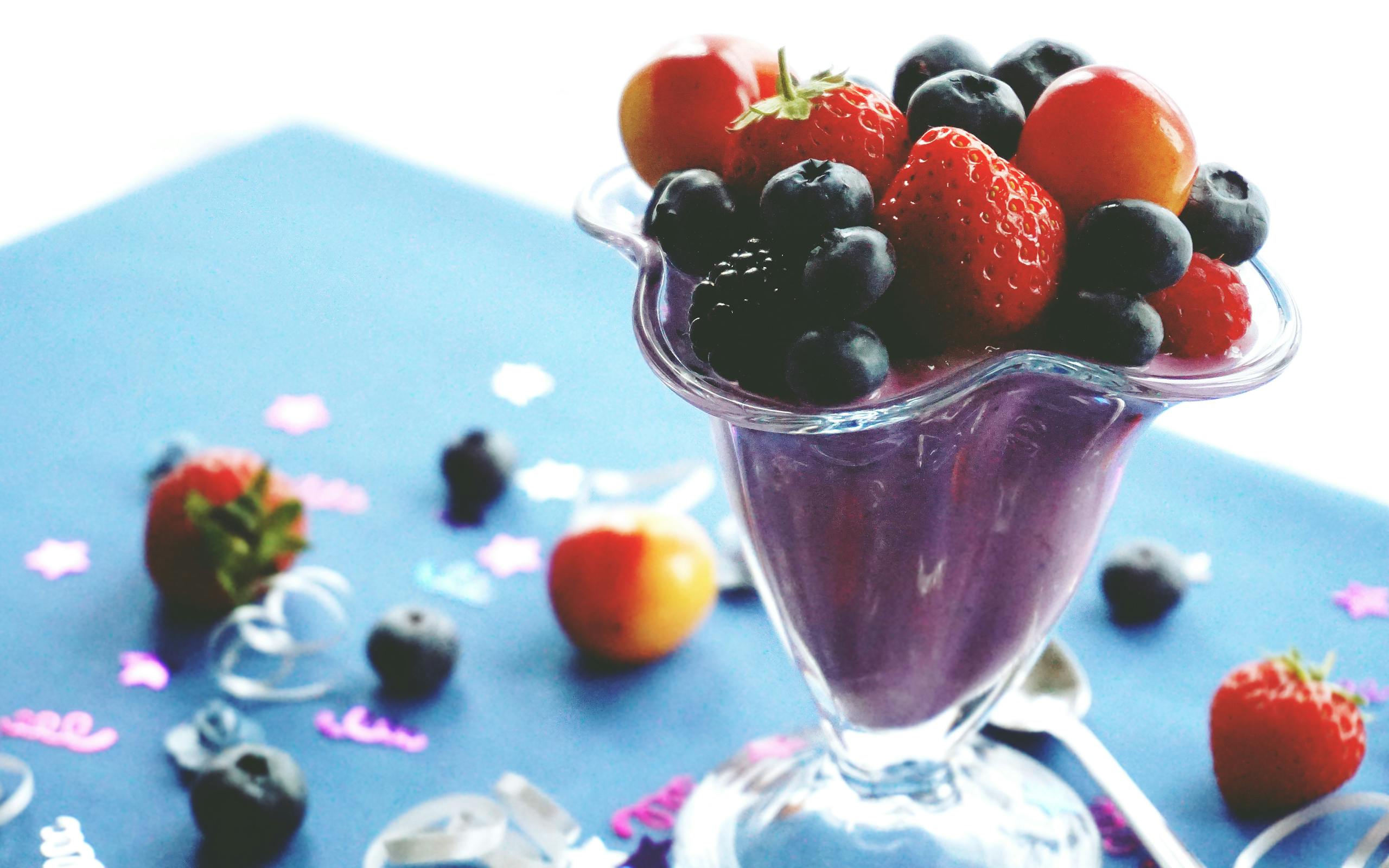 Delicious and healthy mixed berry smoothie topped with fresh fruits. Perfect summer refreshment.